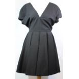 CHRISTIAN DIOR, BLACK WOOL DRESS With low V neck, pleated skirt, cup sleeve and black silk lining (