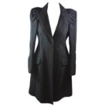 BALENCIAGA, BLACK WOOL COAT With ruffled asymmetric hemline, gold zip along back (size 38). A