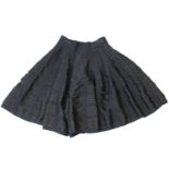 ALAÏA, BLACK VISCOSE AND SILK MINI SKIRT With tight ruffle design throughout and black crossing