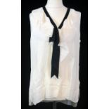CHANEL, WHITE SILK SHIRT The V neckline with black ribbon and folded silk (size 38). A