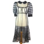 LOUIS VUITTON, BLACK SHEER 'SILK' DRESS With raglan sleeves, peter pan collar, hidden popper