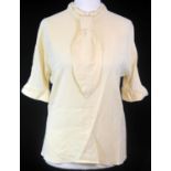 BALENCIAGA, CREAM SILK SHIRT With short sleeves and tie design along front (size 40). B