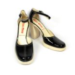 MIU MIU, BLACK PATENT HEELS With a cream platform, heel and stitching (size 39). (heel 11cm) B