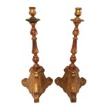 A LARGE PAIR OF 19TH CENTURY PLANISHED GILT WOOD TORCHÈRE CANDLESTICKS The turned columns, on