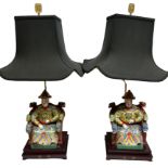 A PAIR OF CHINESE DESIGN TABLE LAMPS Modelled with seated ceramic figures, raised on platform bases.