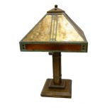 IN THE MANNER OF TIFFANY, AN ART DECO DESIGN OAK TABLE LAMP The tapering form shade with