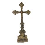 A LATE 19TH/EARLY 20TH CENTURY WHITE METAL OVERLAID CRUCIFIX Baroque form with brass figure of