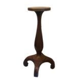 A LATE 19TH/EARLY 20TH CENTURY MAHOGANY TORCHÈRE The circular top raised a bulbous faceted column