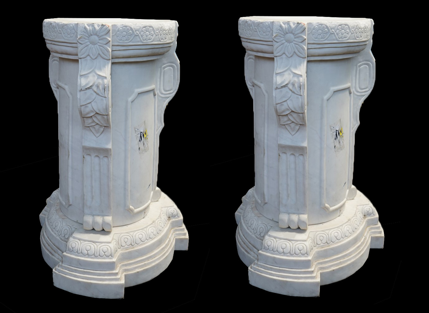 A PAIR OF DECORATIVE CARVED WHITE MARBLE PEDESTAL COLUMNS Decorated with flowers and foliage, raised