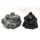 A CARVED GREEN STONE STATUE OF A BUDDHA Along with a bronzed resin example. (largest 18cm)