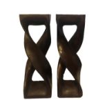 A PAIR OF CONTEMPORARY HARDWOOD TORCHÈRES Raised on two candy twist columns. (30cm x 30cm x 92cm)