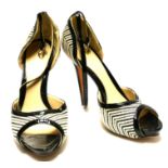 ALEXANDER MCQUEEN, A PAIR OF BLACK PATENT LEATHER AND CREAM OPEN TOE HEELS (size 38.5). Condition: A