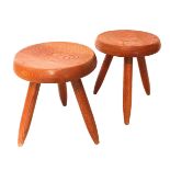 CHARLOTTE PERRIAND, 1903 - 1999, A PAIR OF OAK STOOLS The circular tops on turned tapering legs. (