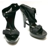 BURBERRY, A PAIR OF BLACK PATENT LEATHER AND CANVAS OPEN TOE AND ANKLE STRAP HEELS (size 39).
