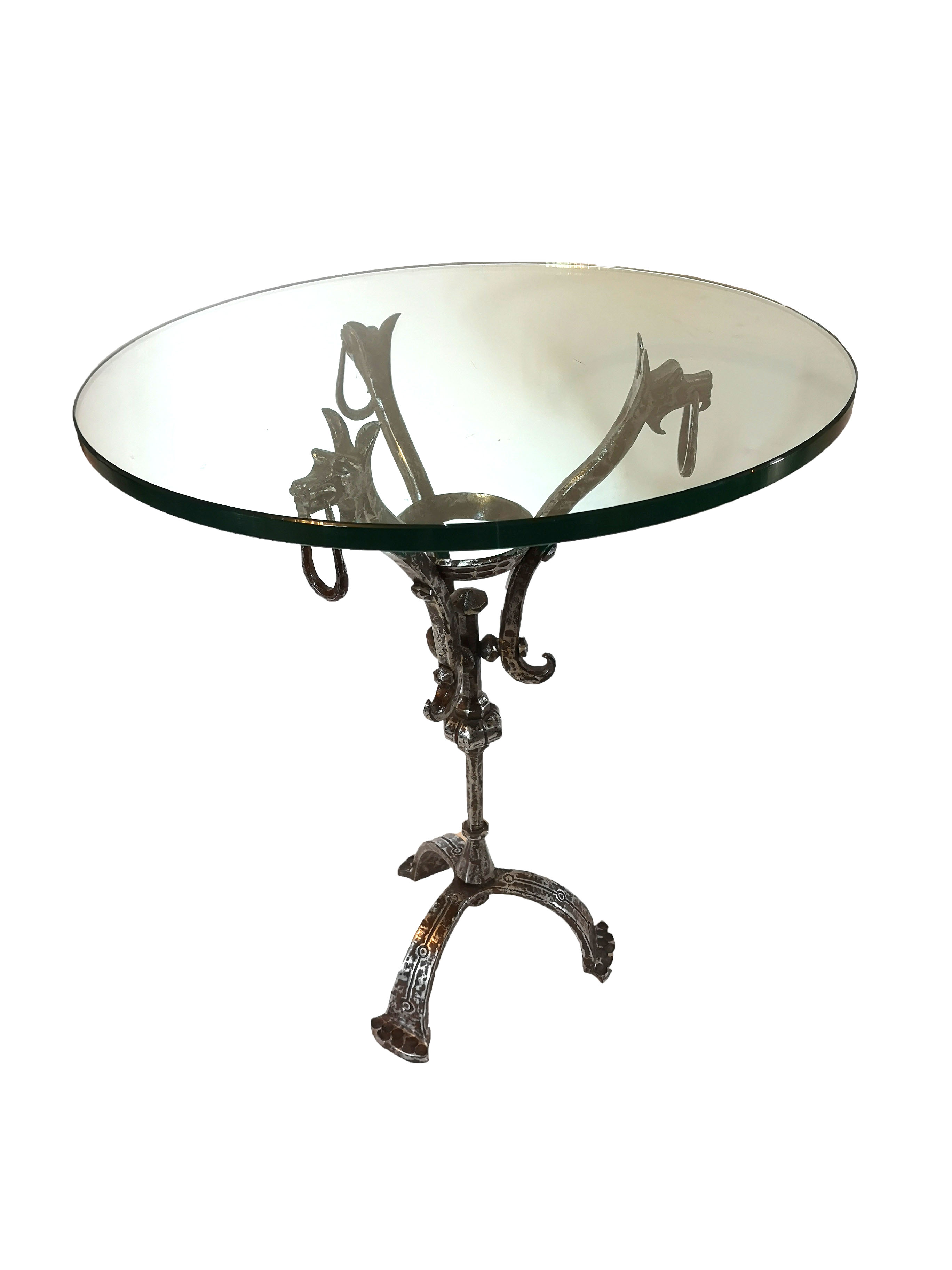 A POLISHED STEEL CAFÉ TABLE The circular plate glass top on a polished steel and aluminium base,