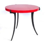 ALLEGRA HICKS, A CIRCULAR OCCASIONAL TABLE The red laminate top raised on three coated aluminium