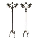 A PAIR OF WROUGHT IRON FLOOR STANDING FIVE BRANCH CANDELABRAS With scrollwork and twist square