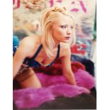 AMANDA ELIASCH, ORIGINAL COLOUR PHOTOGRAPH Semiclad female kneeling on a bed with a pink rug,