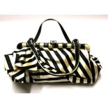 VALENTINO, BLACK AND CREAM STRIPED CLUTCH With enamelled and diamanté clasp. Condition: A