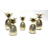 PARKS, LONDON, A SET OF FIVE PINEAPPLE FORM CANDLESTICKS Varying sizes with incised decoration,