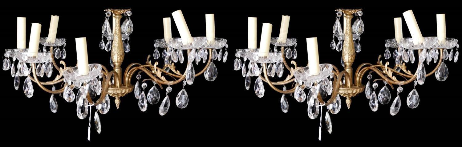 A PAIR OF 20TH CENTURY BRASS AND CUT GLASS CHANDELIERS Each having embossed decoration to frame,