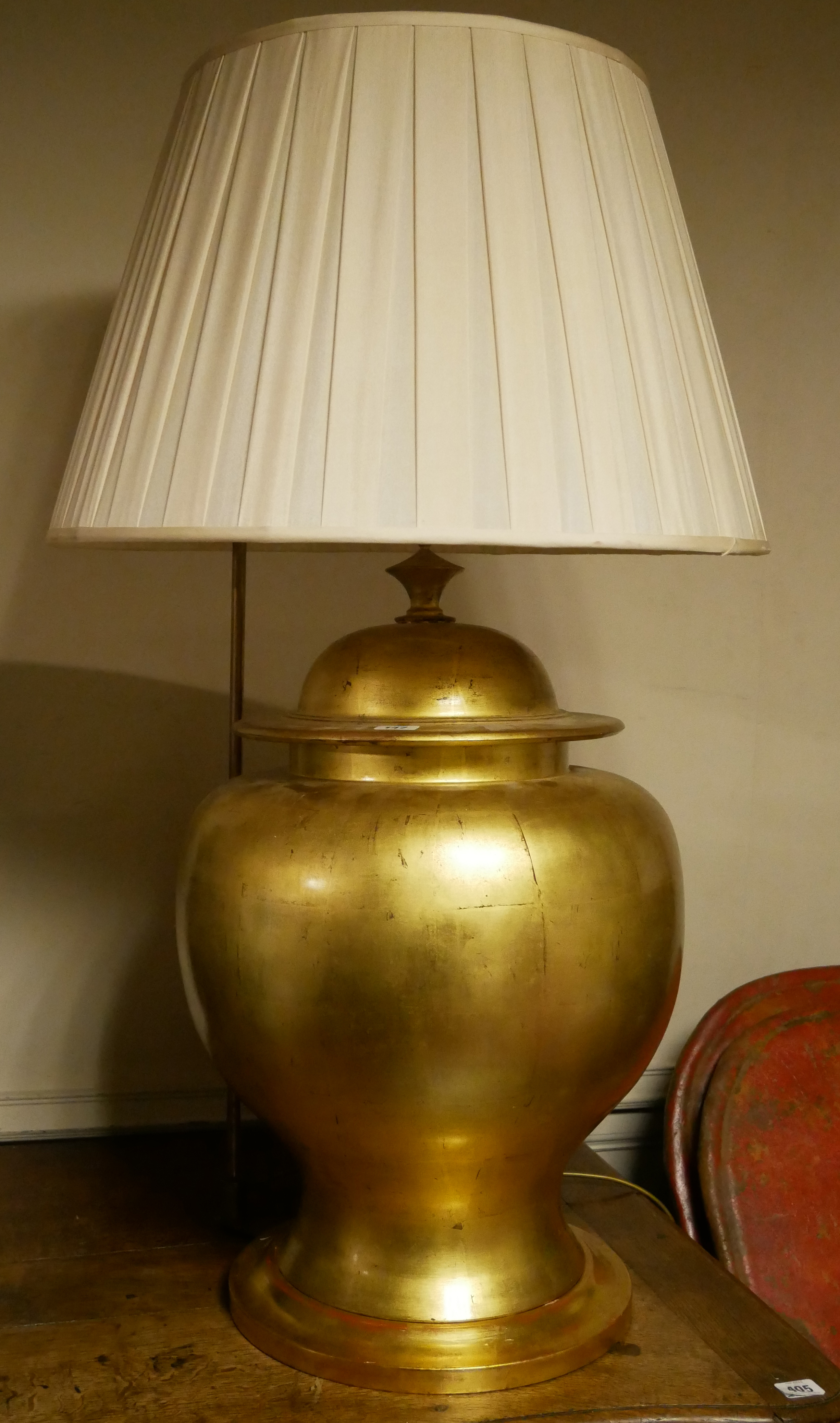 A LARGE GOLD CERAMIC BALUSTER VASE AND COVER Converted to a table lamp with cream shade, on giltwood