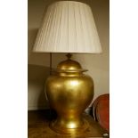 A LARGE GOLD CERAMIC BALUSTER VASE AND COVER Converted to a table lamp with cream shade, on giltwood