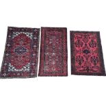 A COLLECTION OF THREE PERSIAN BEDOUIN WOOLLEN RUGS Each having motifs on red fields with running