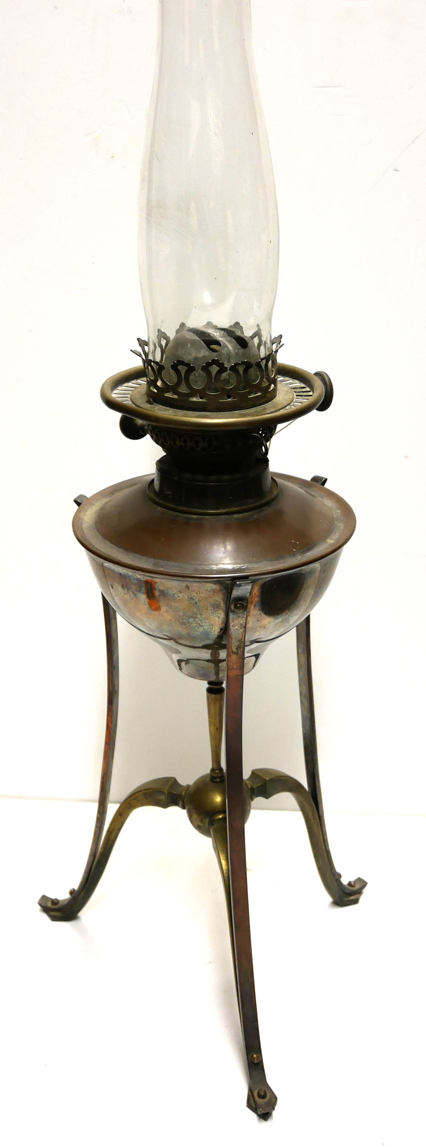 A 19TH CENTURY COPPER AND BRASS OIL LAMP Having a circular well and raised on tripod legs, marked '