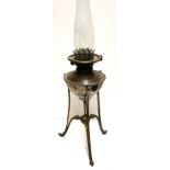 A 19TH CENTURY COPPER AND BRASS OIL LAMP Having a circular well and raised on tripod legs, marked '