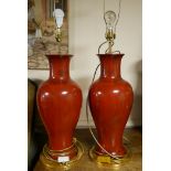 TWO LARGE CERAMIC BALUSTER TABLE LAMPS Maroon with cream shades, on giltwood stands. (65cm)