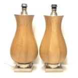 A PAIR OF SHAPED SNAKE SKIN LAMPS Raised on chrome square section bases. (h 54cm)