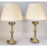 A PAIR OF VICTORIAN GOTHIC BRASS ALTAR CANDLESTICK TABLE LAMPS With pierced tops over candy twist