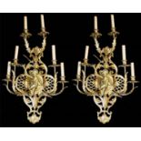 A LARGE PAIR OF EARLY 20TH CENTURY POLISHED BRASS SIX BRANCH WALL SCONCES With drip trays above