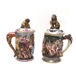 NAPLES, TWO TANKARDS AND COVERS Decorated in relief with cavorting putti and Christians being thrown