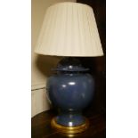 A LARGE BLUE CERAMIC BALUSTER VASE AND COVER Converted to a table lamp with cream shade, on giltwood