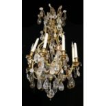 A 19TH CENTURY FRENCH GILT ORMOLU EIGHT BRANCH CHANDELIER The scrolling arms decorated with clear