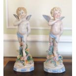 TWO CONTINENTAL HARD PASTE STATUES Winged Cupid's. (37cm)