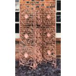 AN EARLY 20TH CENTURY WROUGHT IRON THREE FOLD SCREEN The nine circular panels with hearts and C