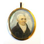 A GEORGIAN WATERCOLOUR ON IVORY MINIATURE PORTRAIT Gent wearing period attire, held in a glazed gilt