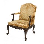 A good Chippendale period mahogany library chair,the scrolled and carved arms over a frieze, crisply