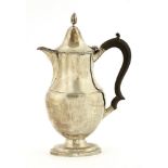A silver hot water jug,by Nathan & Hayes, Chester 1906, of plain oval form with reeded bands and a