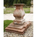 A stone sundial pedestal,of square baluster shape, standing on a substantial stone square two-part