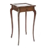 An Edwardian mahogany bijouterie table,with an hinged and glazed top, brass stringing, cast bronze