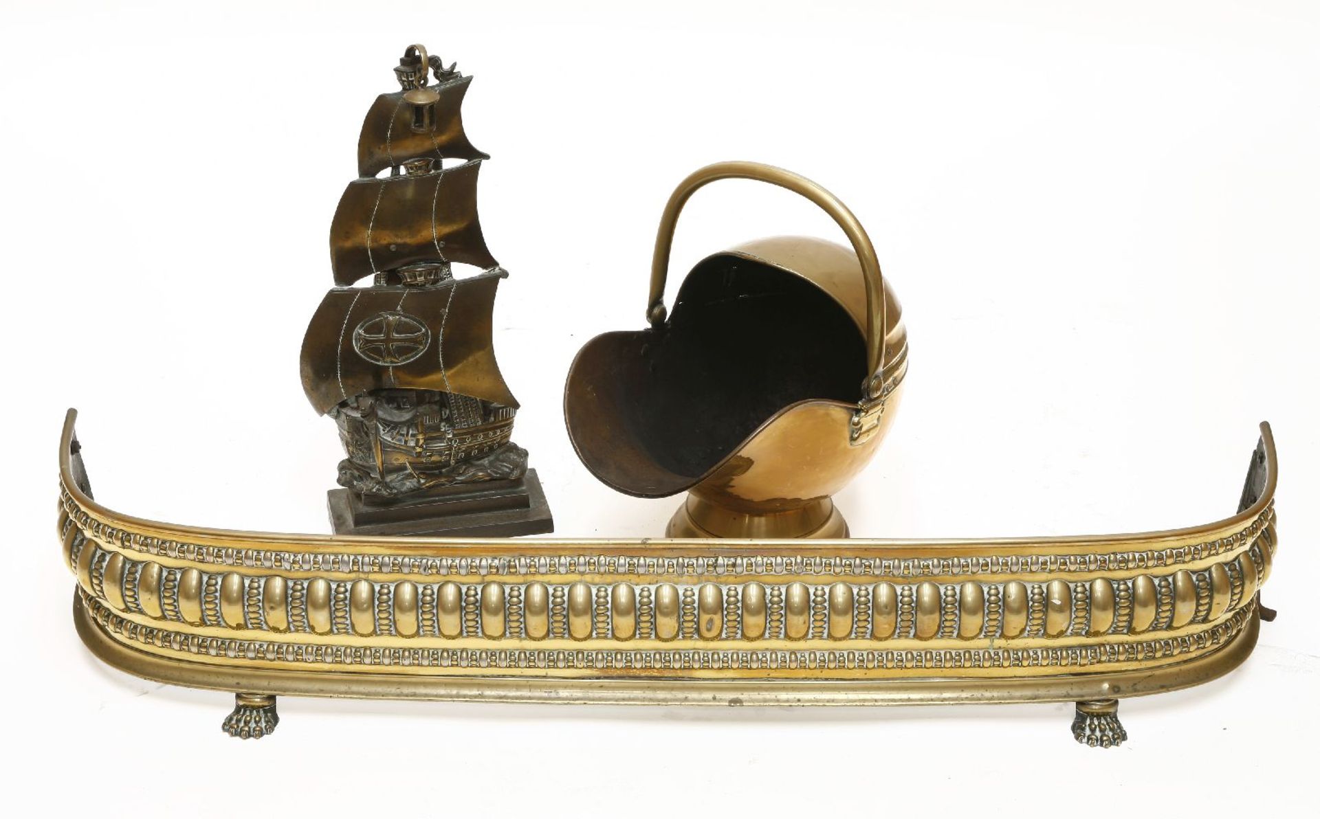 Brass fireplace furniture,comprising:a coal scuttle,a fender on paw feet,124cm, anda companion set