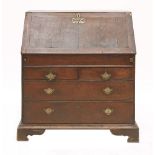 A George II oak bureau,the stepped interior with a well, over two short and two long drawers, within