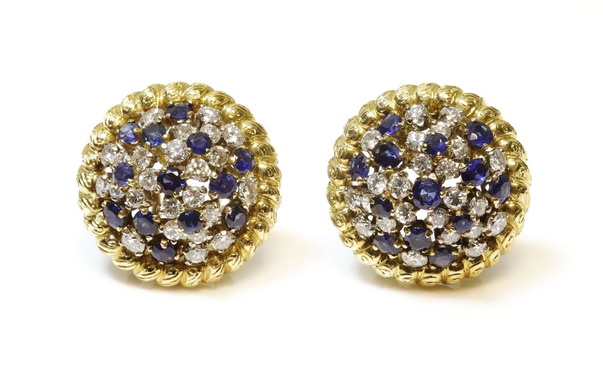 A pair of sapphire and diamond cluster earrings,each circular domed earring set with a dispersed