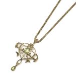 A Edwardian gold peridot and seed pearl pendant/brooch, an oval cut peridot millegrain set to a