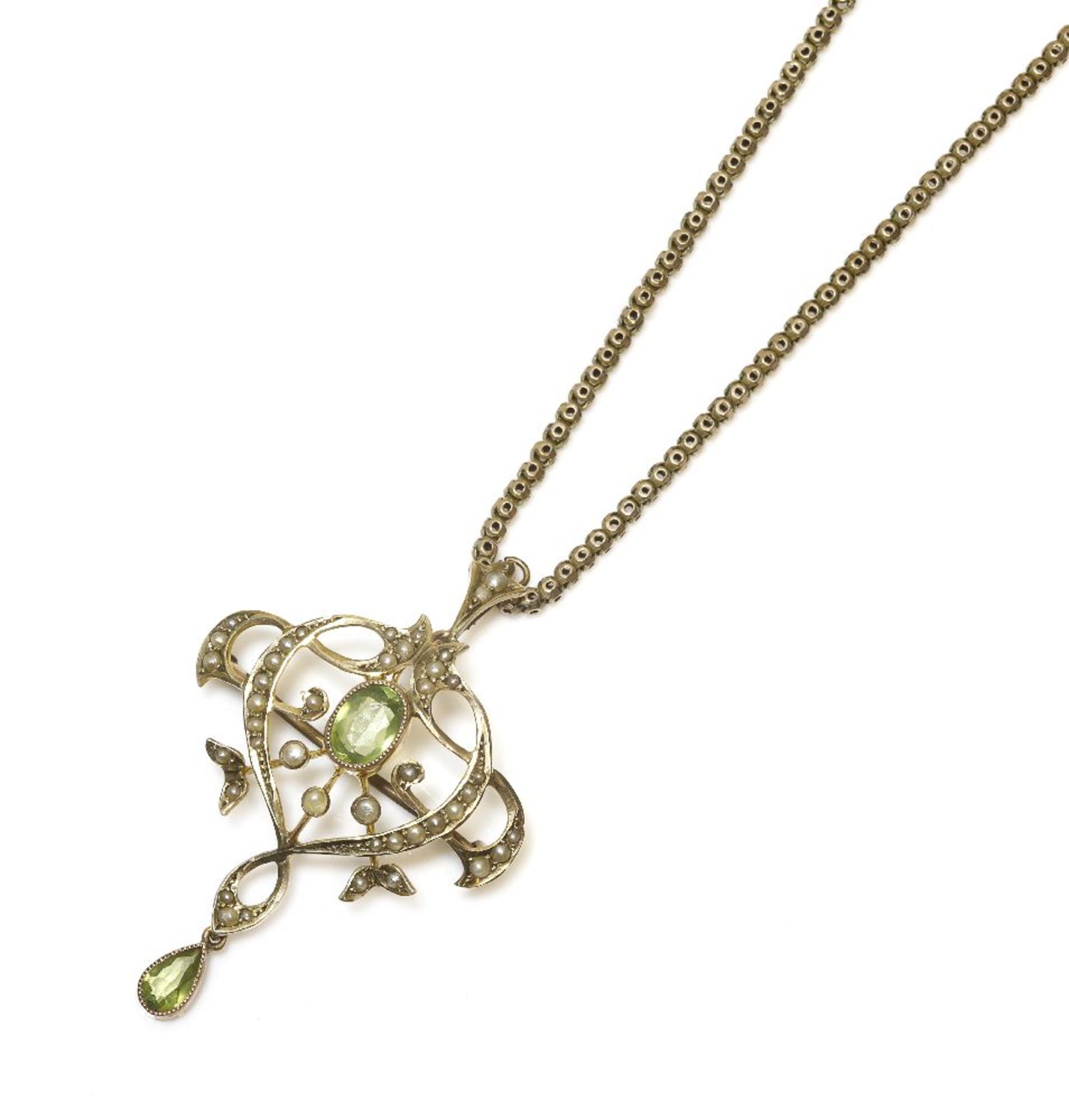 A Edwardian gold peridot and seed pearl pendant/brooch, an oval cut peridot millegrain set to a