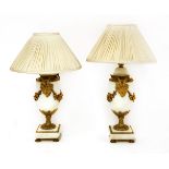 A pair of white marble table lamps,of urn shape on square plinths, with ornate gilt metal mounts,